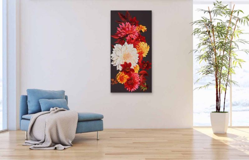 Canvas print of multi-coloured dahlias on dark background on a wall in a living room. Painting by UK floral artist Sarah Caswell