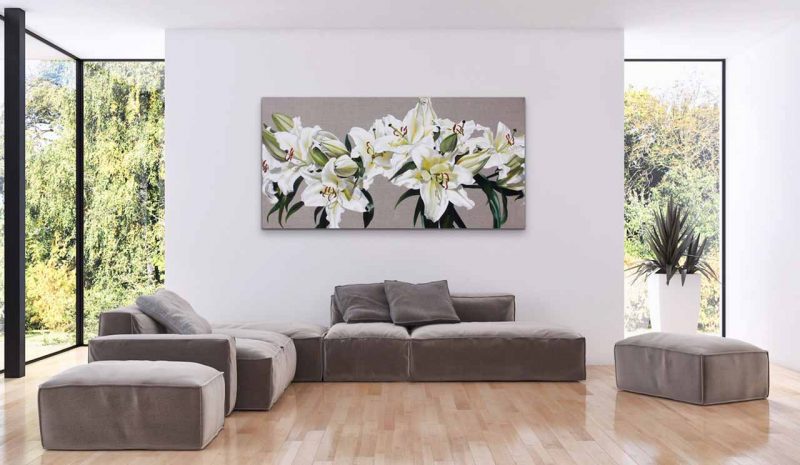 Canvas print of white and green lilies on linen background on a wall in a living room. Painting by UK floral artist Sarah Caswell