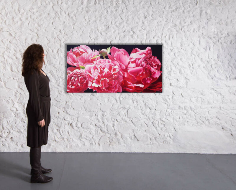 Original painting of magenta peonies on a black background in a gallery